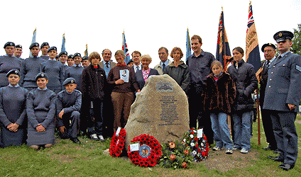 Nathaniel's family and others beside his memorial  