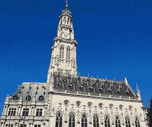 The town hall, with its impossibly high tower and beautiful gilding, stands in the Place des Heroes
