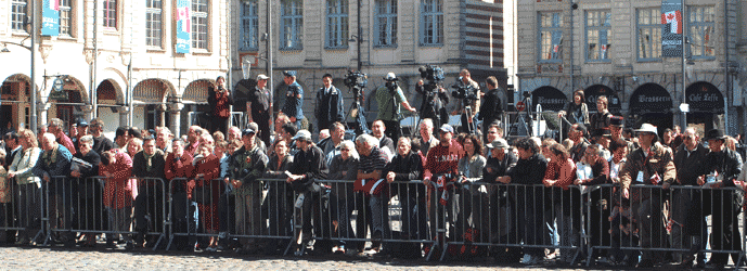 the crowd, with behind them members of the media with cameras