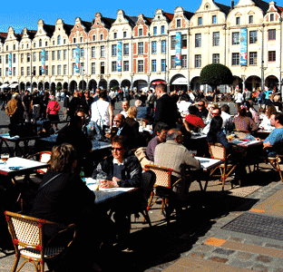 the Place des Heroes after the events - many visitors sitting at tables enjoying a drink in the evening sunshine