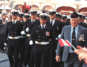 another group, drawing behind them a large gun