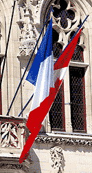 the French and Canadian flags, fixed to the balcony of the town hall
